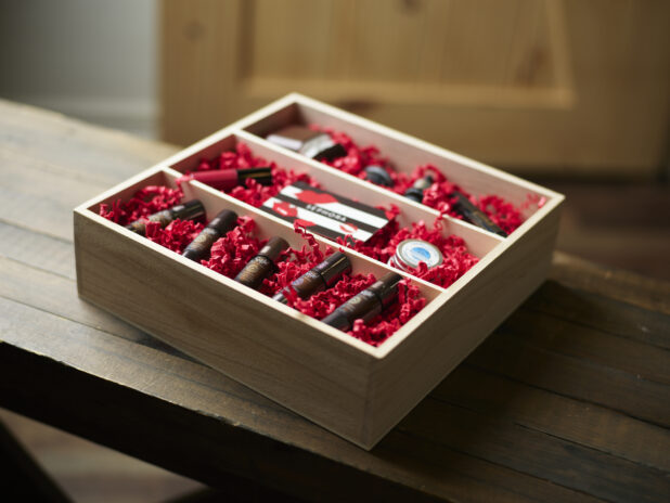 A Valentine's Day gift box with compartments, essential oils, and a gift card