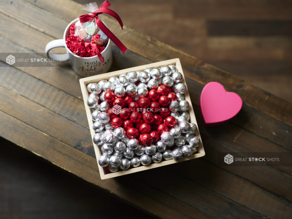 A Valentine’s Day gift box with red and silver chocolate foil balls and accompanying mug