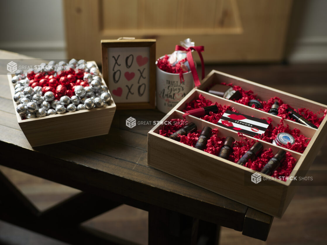 Wooden gift boxes for Valentine's Day with chocolates, essential oils and an accompanying mug