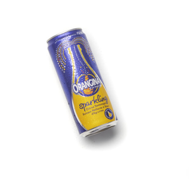 Sparkling Orangina, citrus beverage, in a can on an angle on a white background