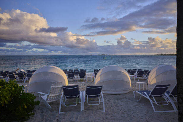 Rows of Beach Chairs and Domed Tents Facing Turquoise Waters on a White Sandy Beach in a Resort in Nassau, Bahamas