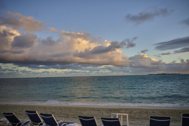 Skyline View of Clouds Over Blue Waters on a Sandy Beach in a Resort in Nassau, Bahamas at Dusk