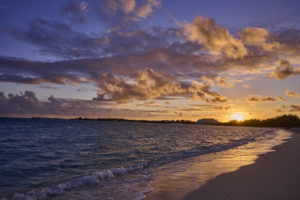Landscape View of a Sandy Tropical Beach Shoreline and Waves at Sunset or Sunrise in Nassau, Bahamas - variation