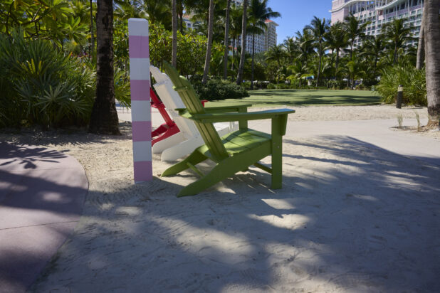 Colourful Wooden Beach Chairs in a Shady Area on a White Sandy Beach