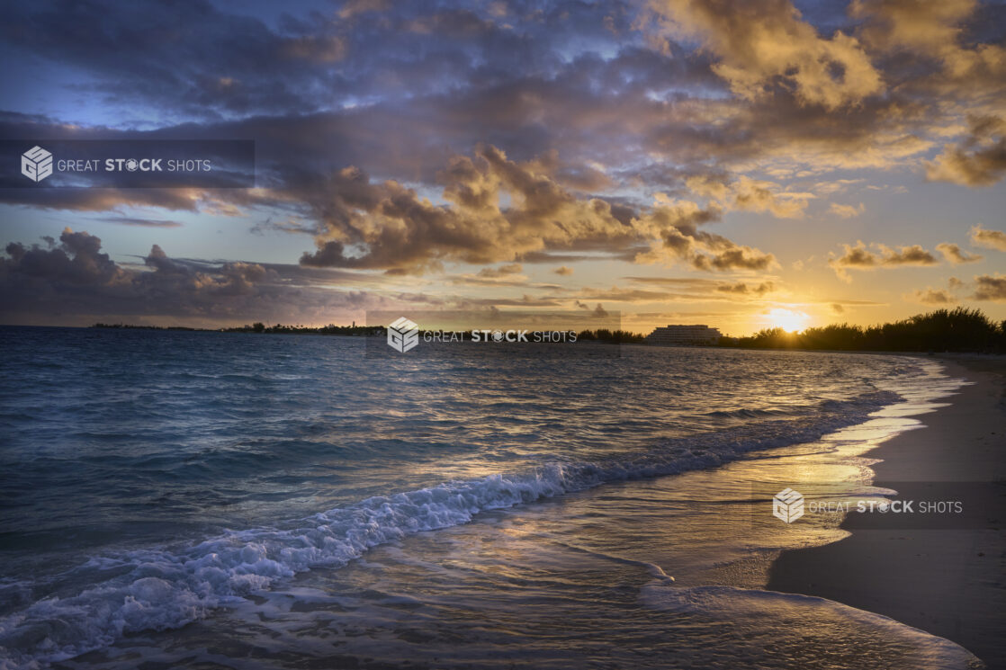 Landscape View of a Sandy Tropical Beach Shoreline and Waves at Sunset or Sunrise in Nassau, Bahamas