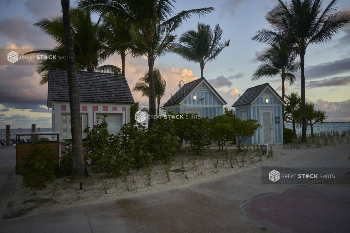 A Row of Colourfully Painted Outdoor Huts and Kiosks on a Sandy Beach in a Resort in Nassau, Bahamas at Dusk