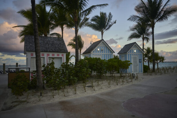 A Row of Colourfully Painted Outdoor Huts and Kiosks on a Sandy Beach in a Resort in Nassau, Bahamas at Dusk