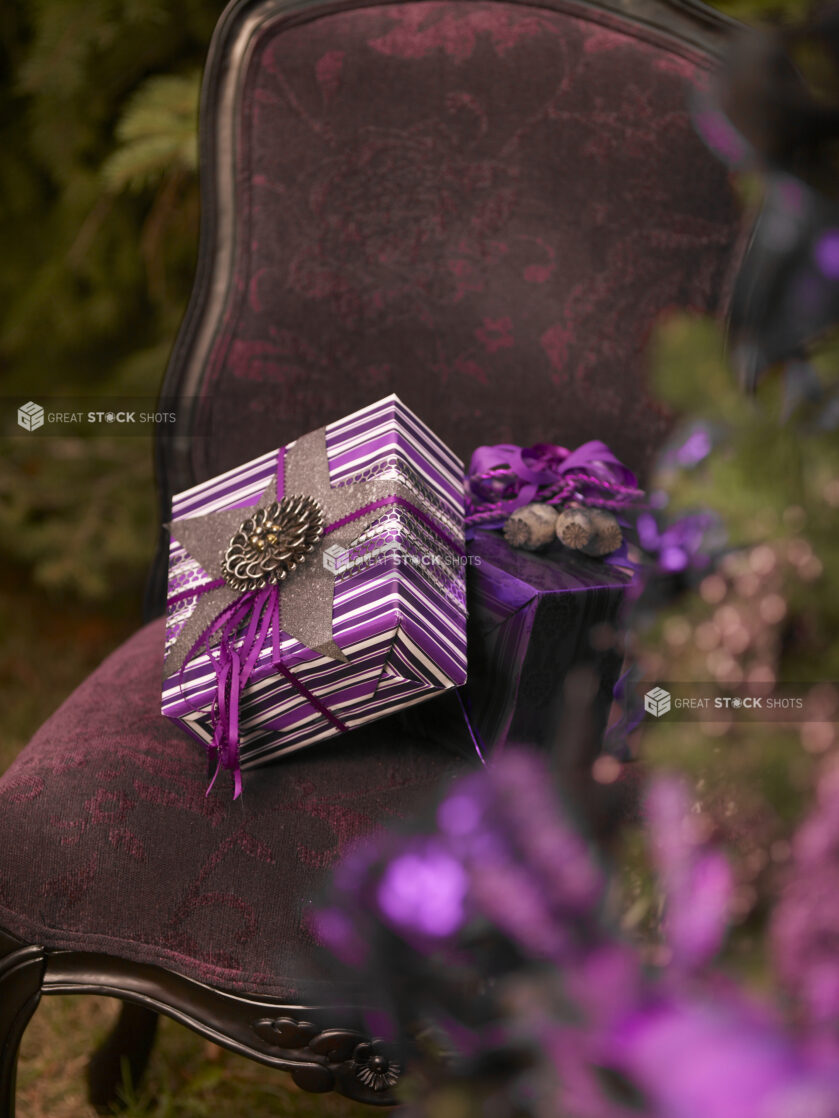 Close Up of a Stack of Purple Gift Boxes on an Antique Dining Chair in an Outdoor Setting