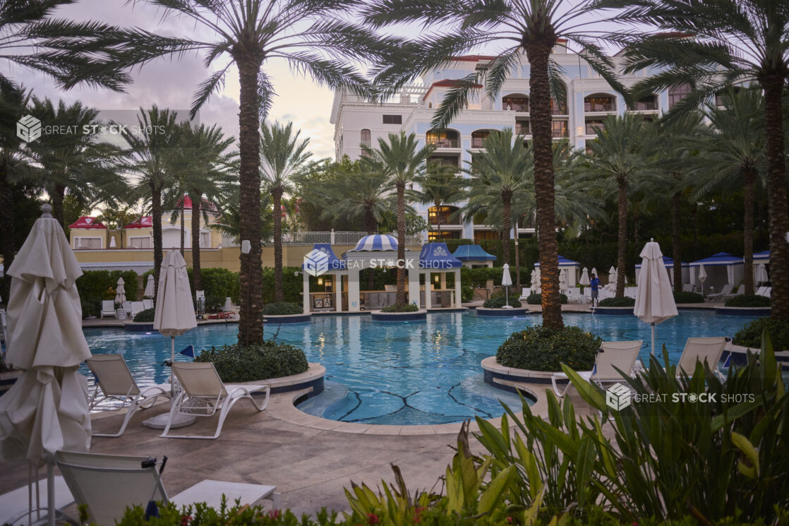 Hotel Resort Pool With Deck Chairs, Beach Umbrellas, Pool Bar and Palm Trees in Nassau, Bahamas