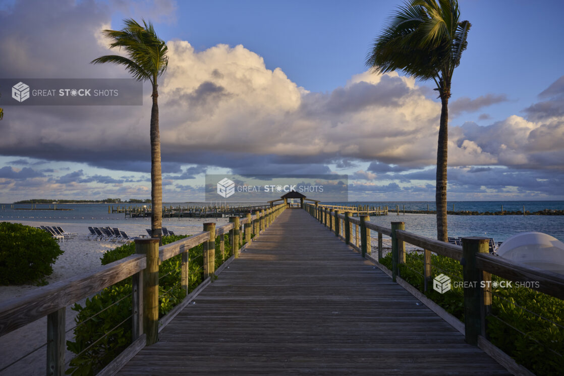 View Down a Wooden Boardwalk and Pier on a Sandy Beach in a Resort in Nassau, Bahamas