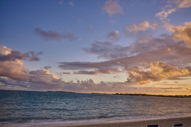 Landscape View of a Sunset Over the Blue Waters on a Sandy Beach in a Resort in Nassau, Bahamas at Dusk