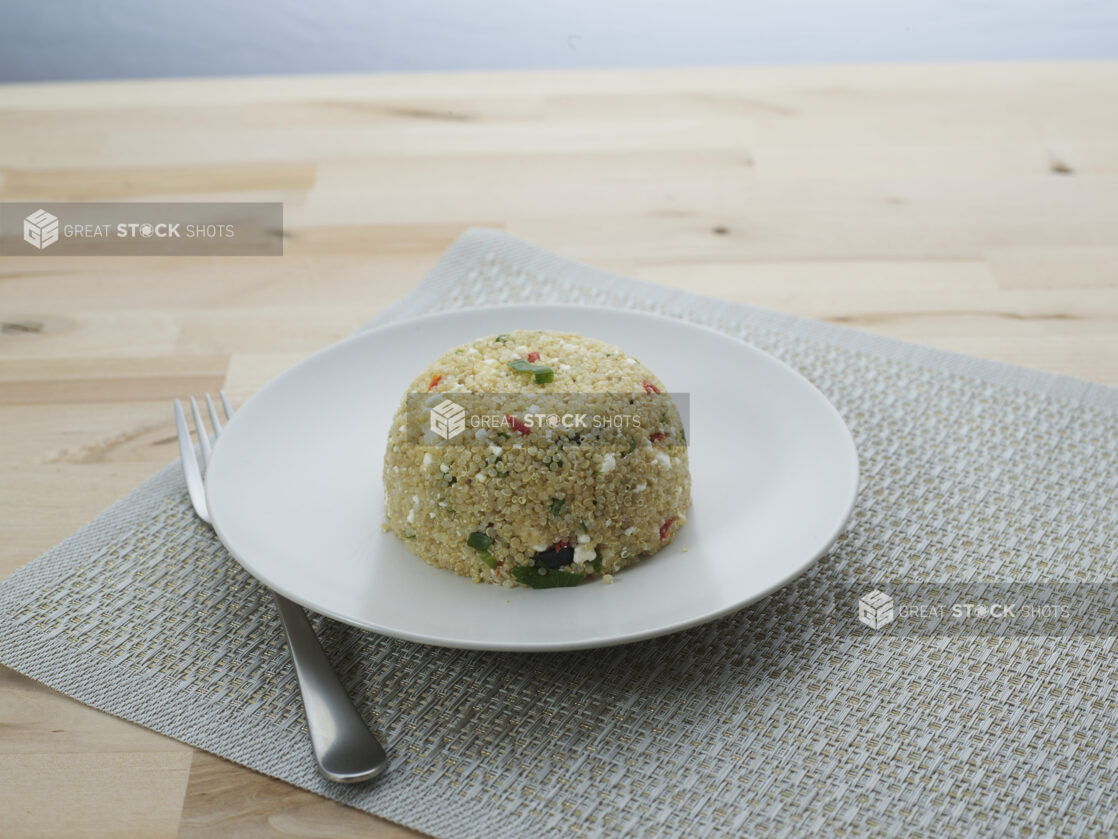 Tuscan quinoa in a mound on a round white plate