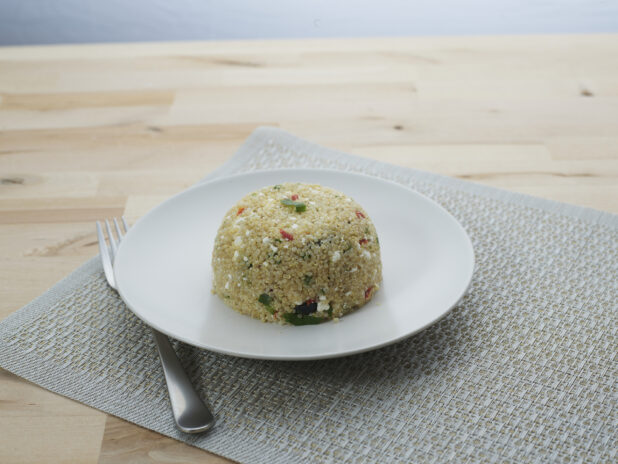 Tuscan quinoa in a mound on a round white plate
