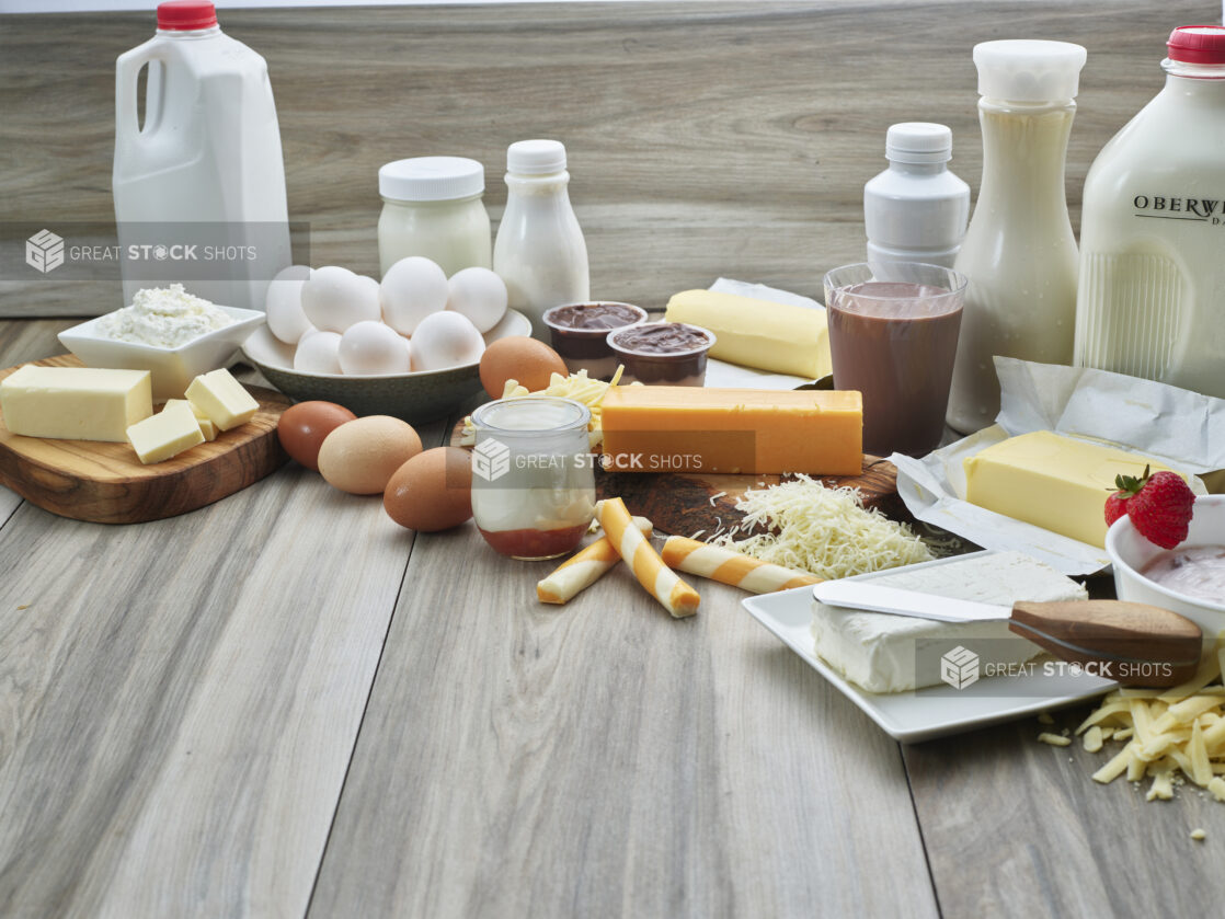 Spread of eggs and dairy products on grey wood background