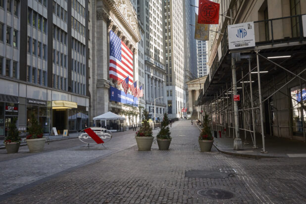 View Down Wall Street in New York City with Cobbled Streets, American Flags and Christmas Decorations