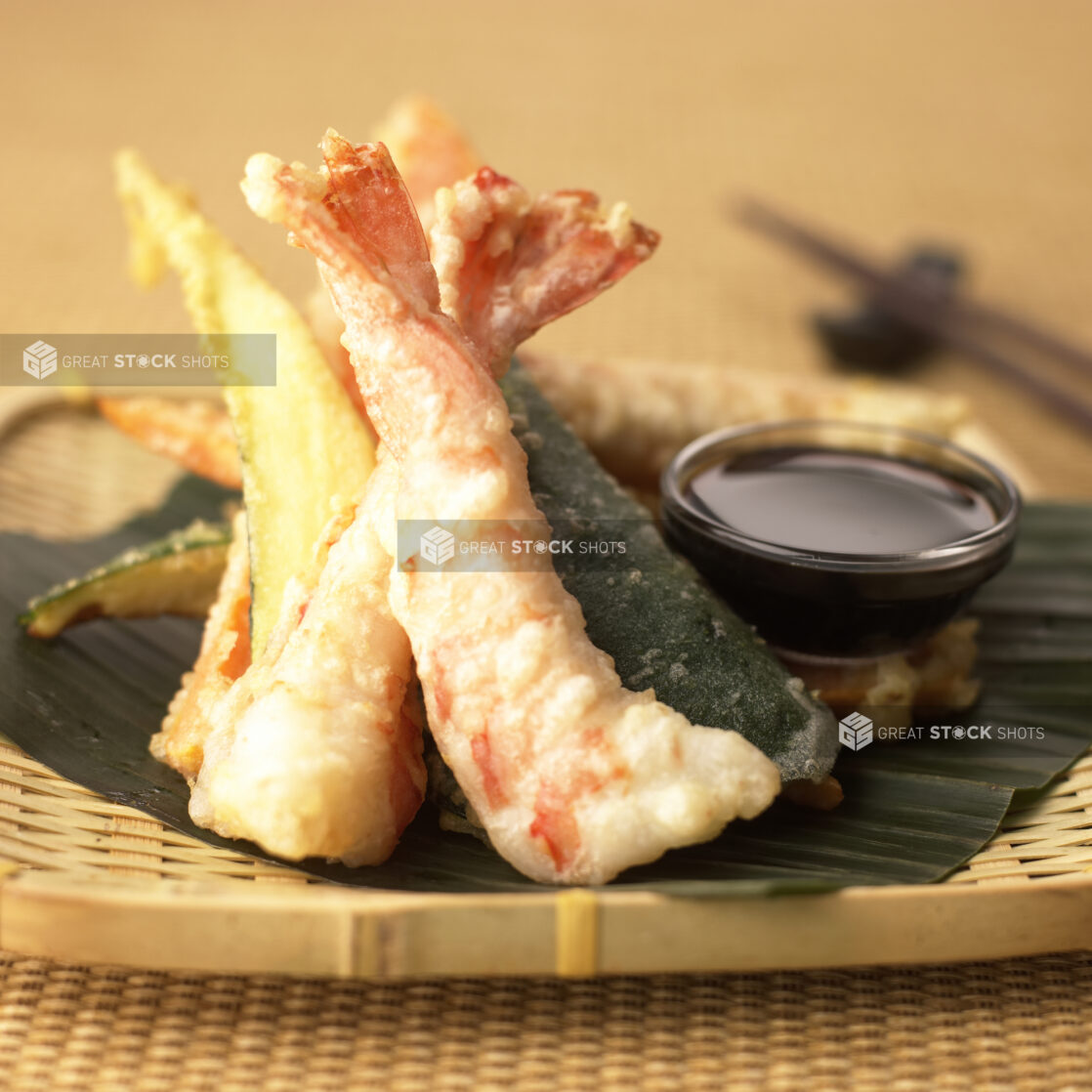 Close Up of a Bamboo Platter with Assorted Shrimp and Vegetable Tempura and a Side of Sauce