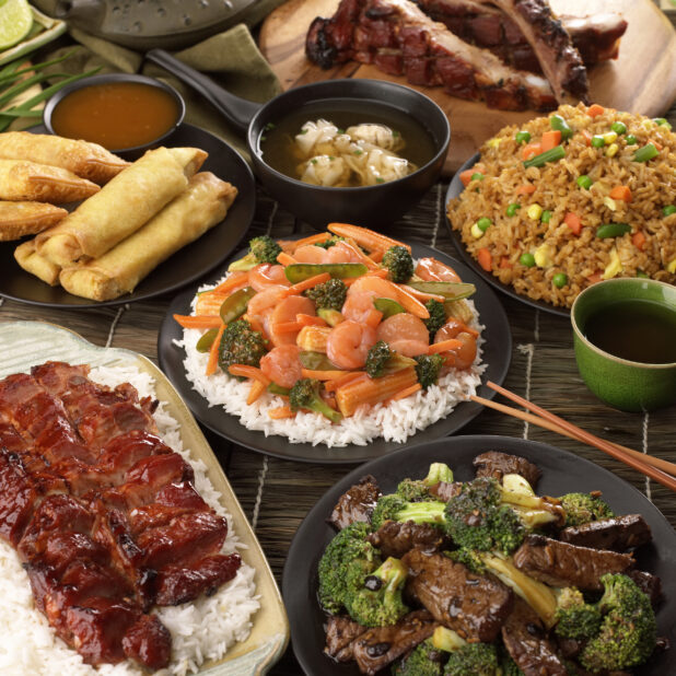 A Group Shot of Popular Chinese Take Out Dishes: BBQ Pork, Beef and Broccoli, Shrimp and Vegetable Stir Fry, Spring Rolls and Fried Rice