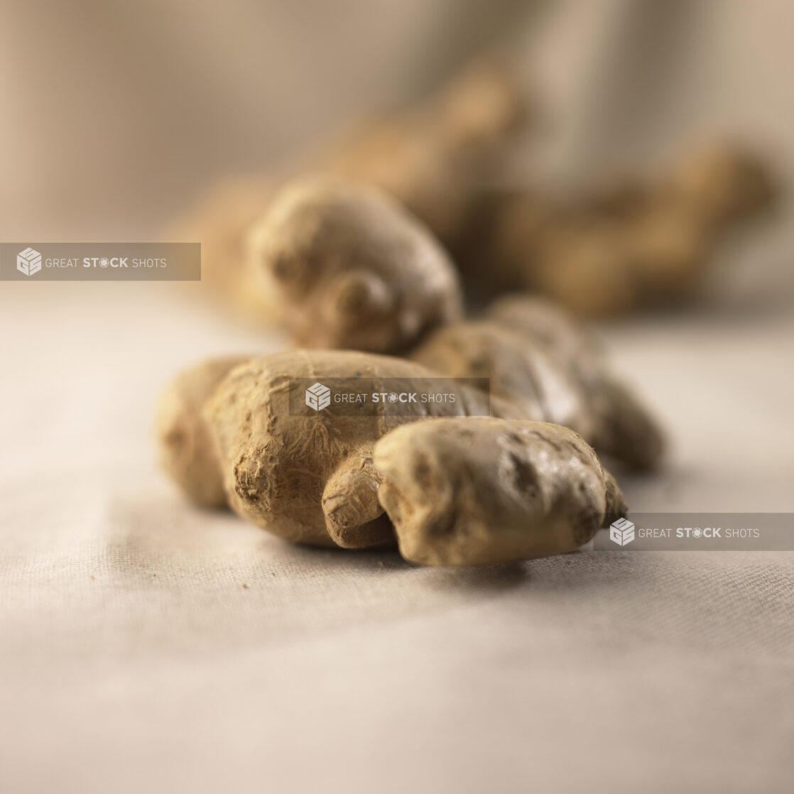 Close Up Shot of a Ginger Root on a Beige Table Cloth