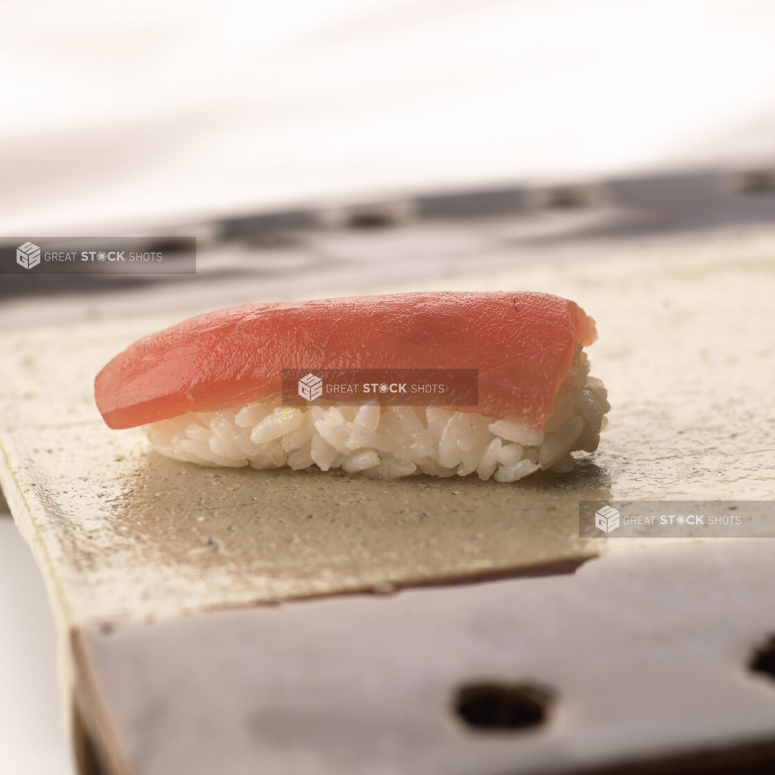 Close Up of a Maguro/Tuna Nigiri Sushi on a Ceramic Dish