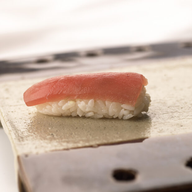 Close Up of a Maguro/Tuna Nigiri Sushi on a Ceramic Dish