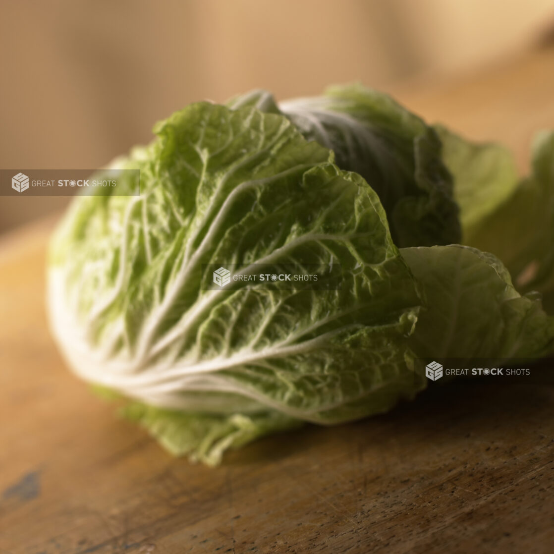 Close Up View of a Head of Nappa/Chinese Cabbage on a Wooden Board