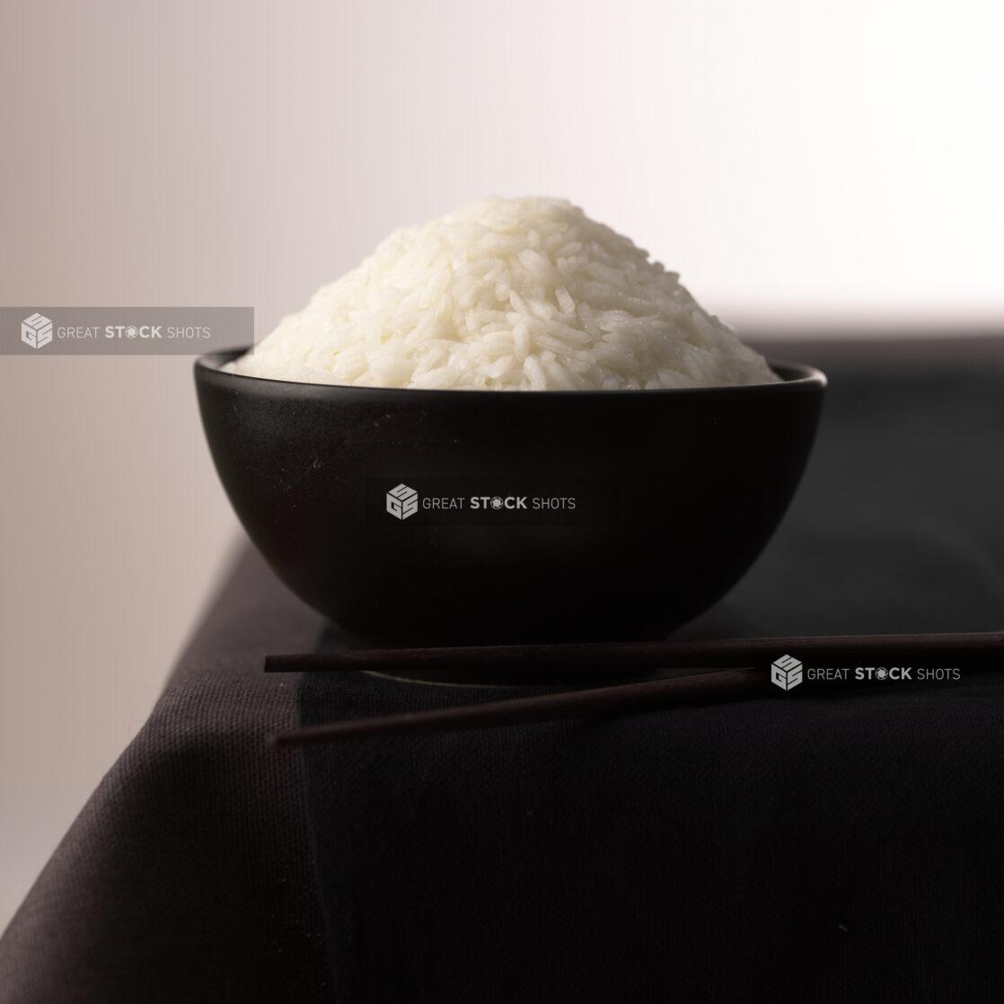 Close Up of a Black Ceramic Bowl of Steamed White Chinese Long Grain Rice