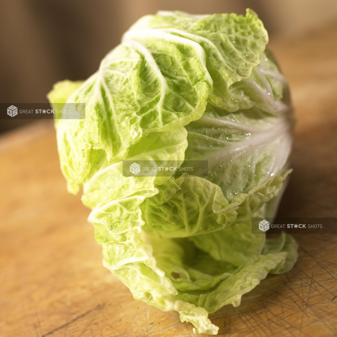 Close Up View of a Head of Nappa/Chinese Cabbage on a Wooden Board - Variation