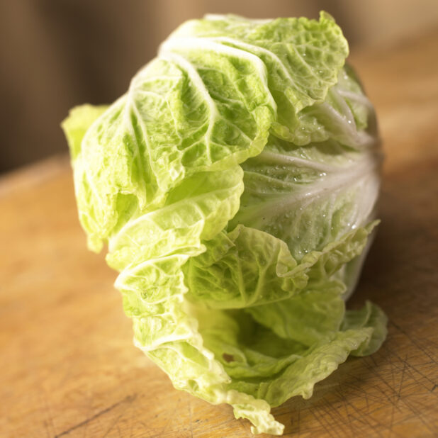 Close Up View of a Head of Nappa/Chinese Cabbage on a Wooden Board - Variation