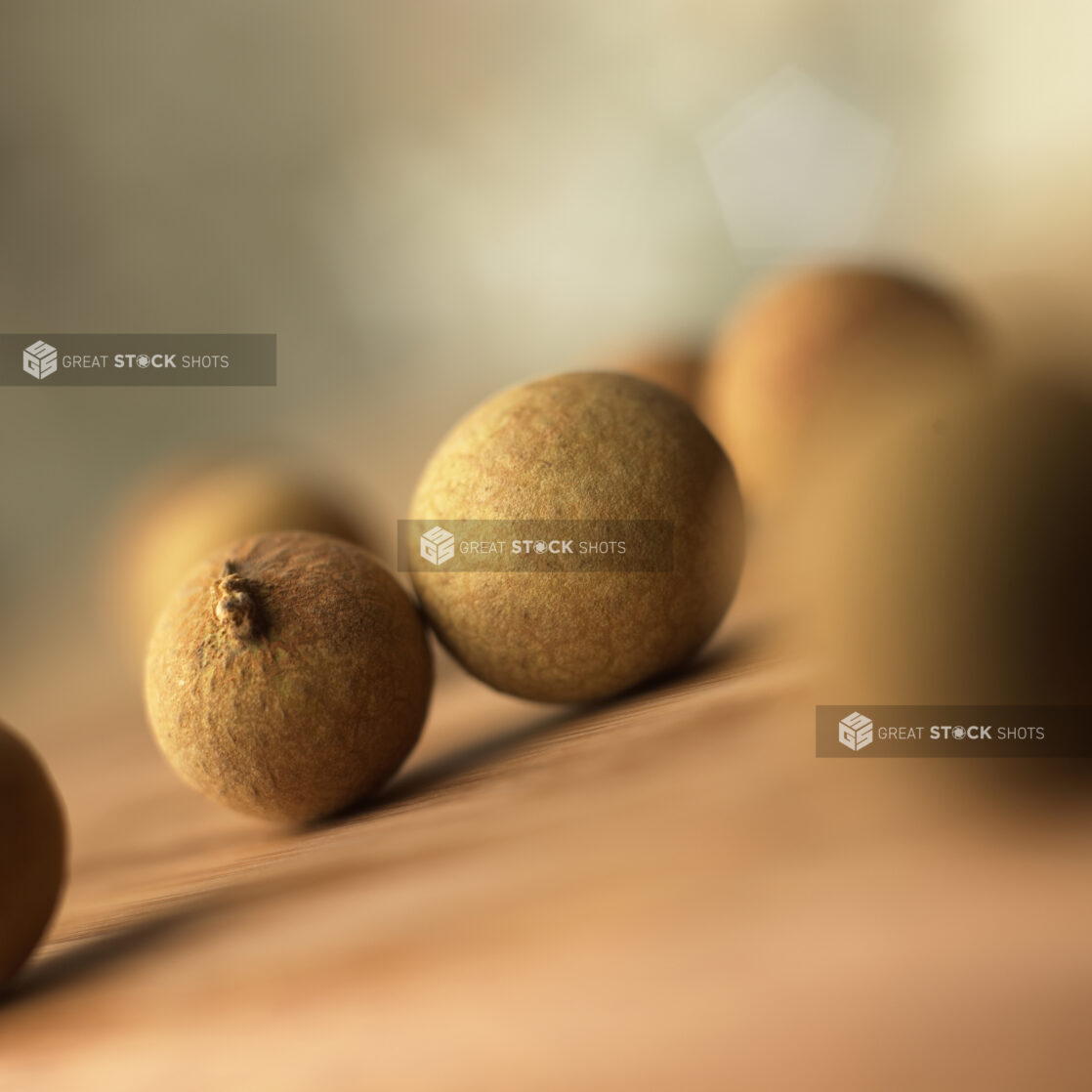 Close Up of Longan – a Type of Chinese Fruit – Unpeeled and Scattered on a Table