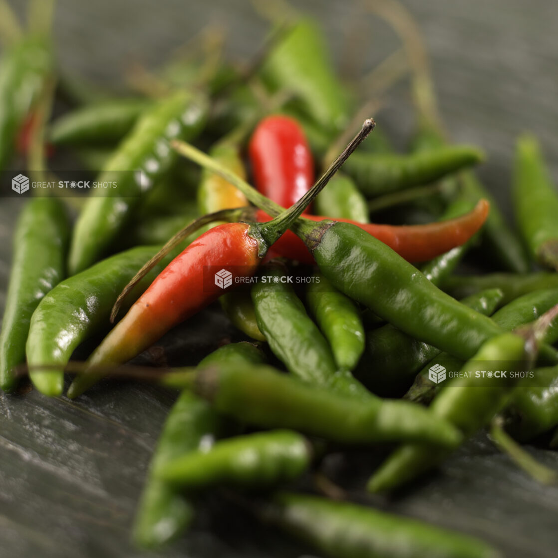 Close Up of Fresh Red and Green Chilli Peppers or Bird's Eye Chili Peppers in an Indoor Setting