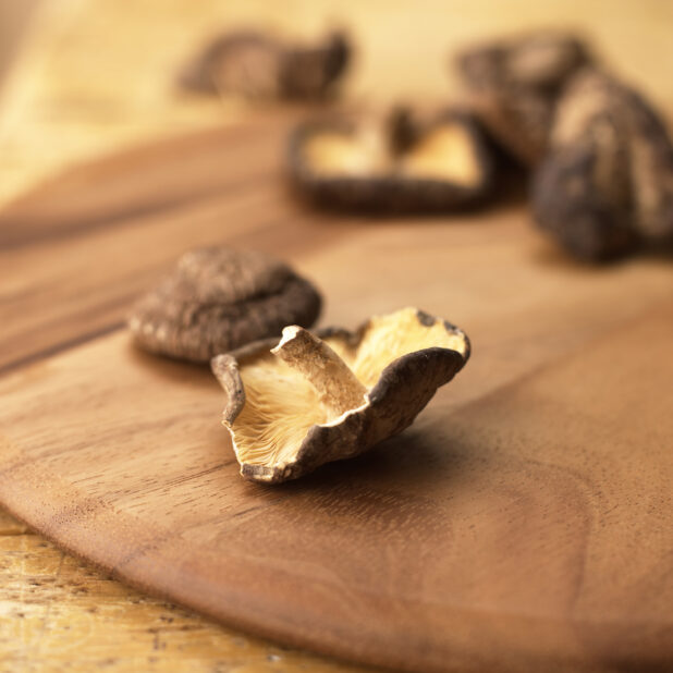 Close Up Shot of Dried Shiitake Mushrooms on a Wooden Board