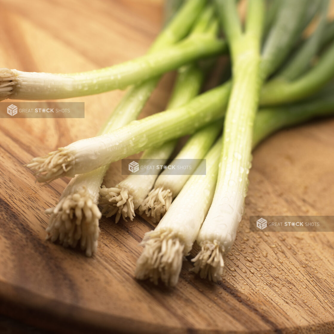 Close Up Shot of the Root Ends of Wild Leek Vegetables on a Wood Board