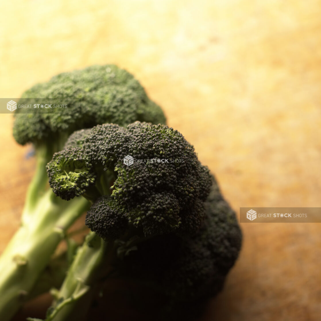 Overhead Shot of Broccoli Heads on a Wooden Board