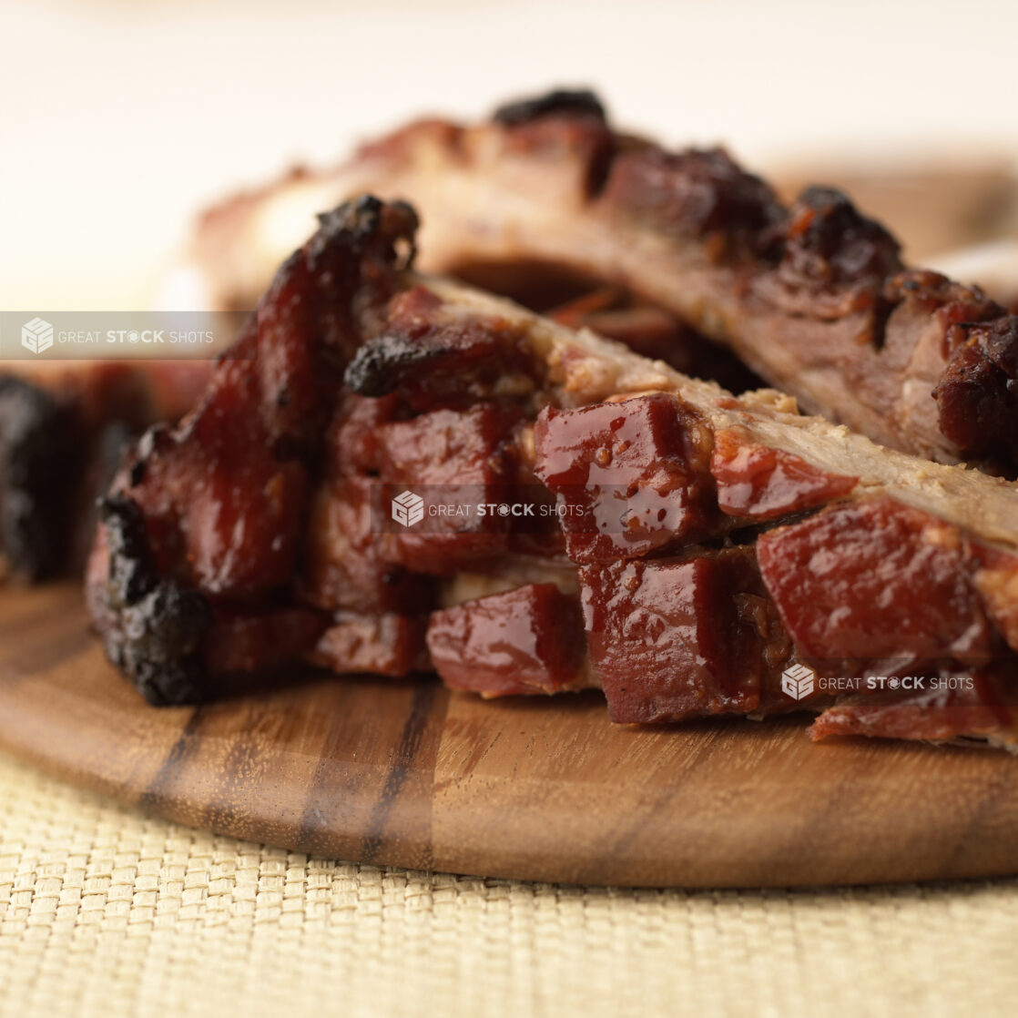 Close-Up of a Wooden Platter of Honey-Glazed BBQ Pork Ribs