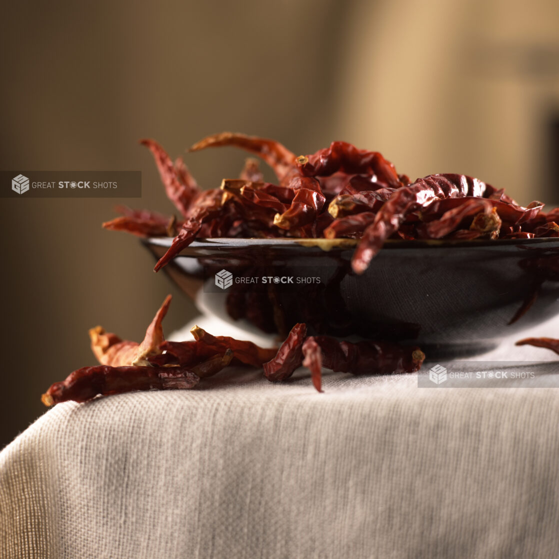 Close Up Shot of Dried Red Chili Peppers in a Black Ceramic Bowl