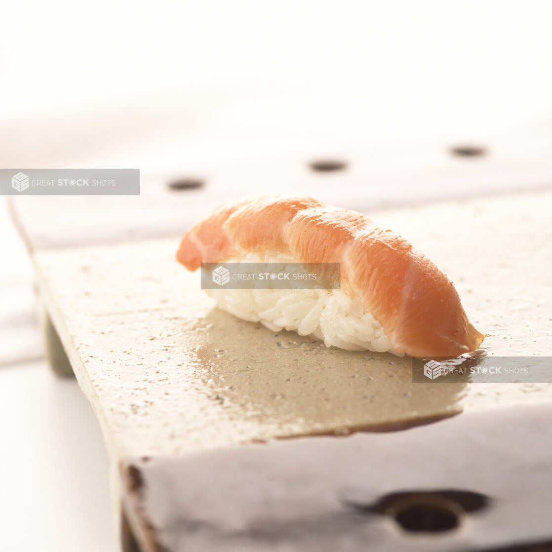 Close Up of a Salmon Nigiri Sushi on a Ceramic Dish