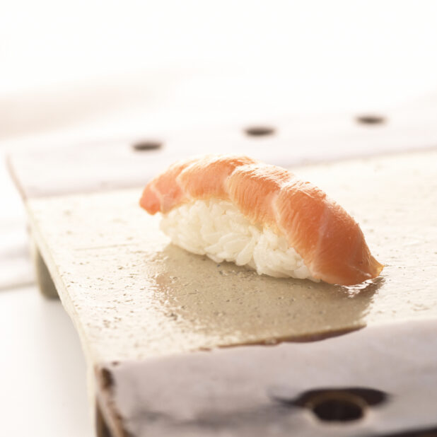 Close Up of a Salmon Nigiri Sushi on a Ceramic Dish