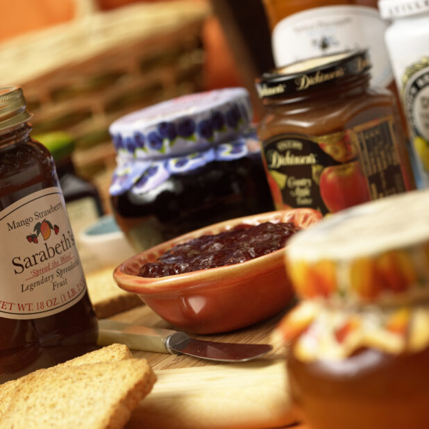 Assorted Fruit Jams and Preserves in Jars and Bowls in an Indoor Setting