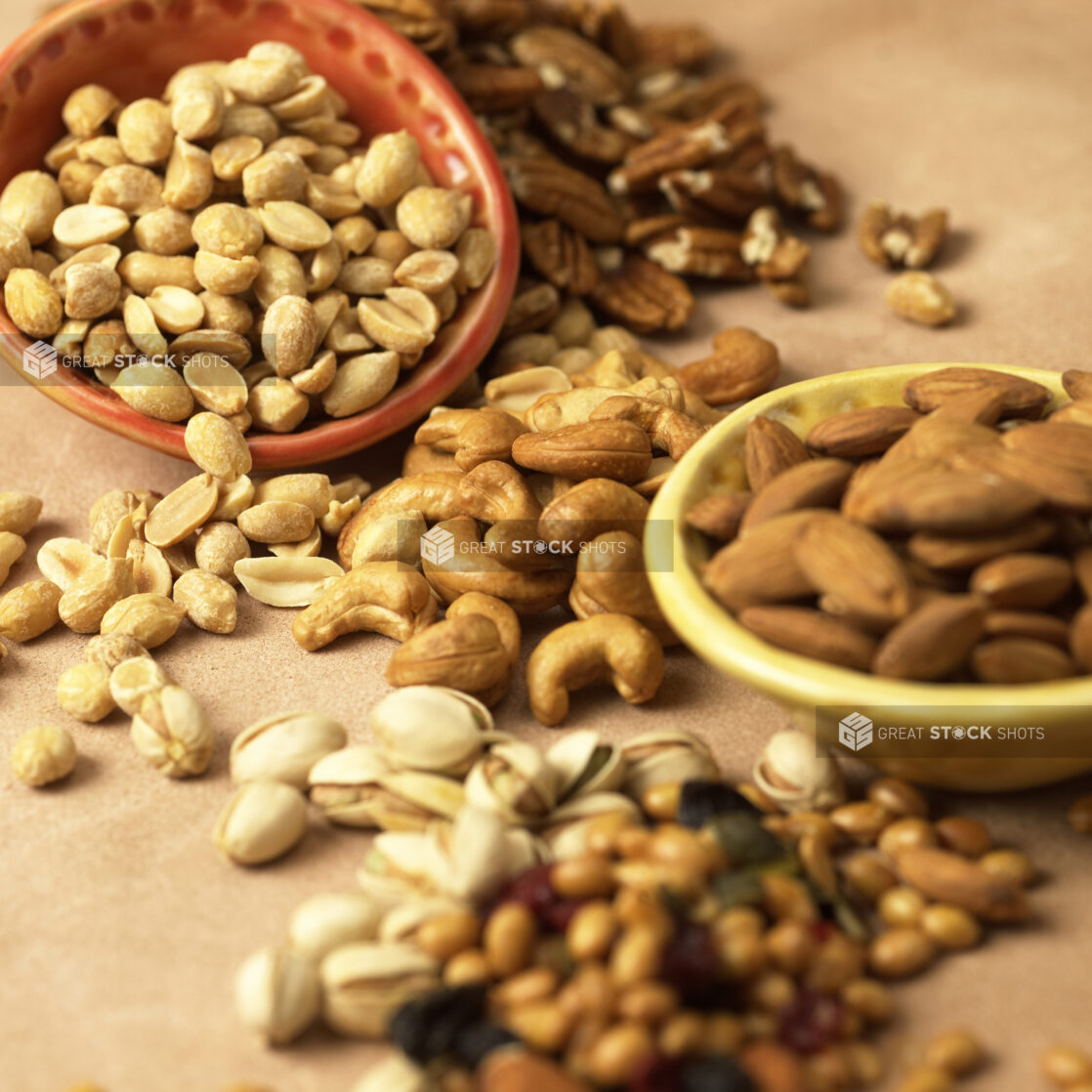 Close Up of Assorted Nuts - Cashews, Peanuts, Almonds, Pistachios and Pecans - in an Indoor Setting