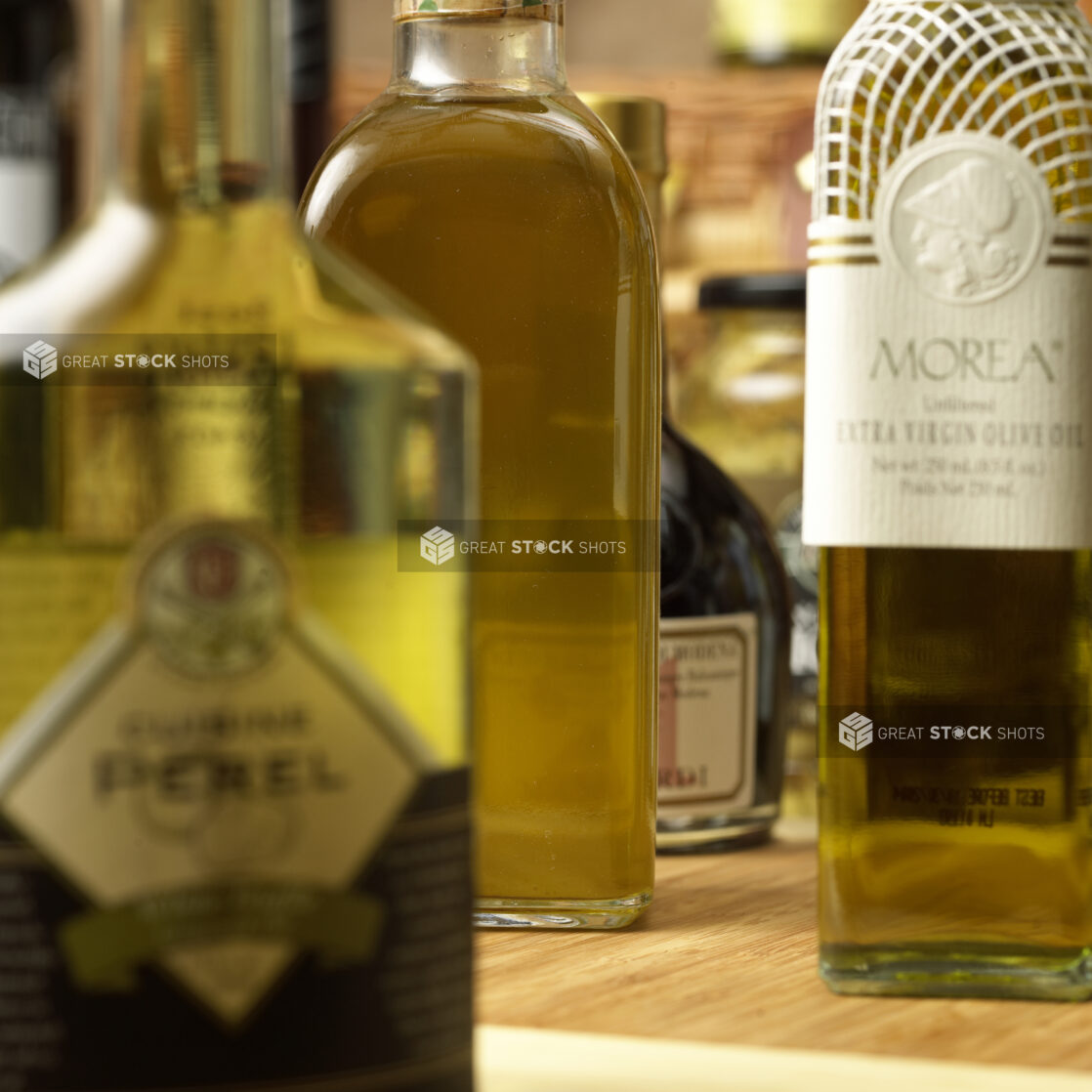 Close Up of an Array of Glass Bottles of Extra Virgin Olive Oil in a Gourmet Grocery Store Setting