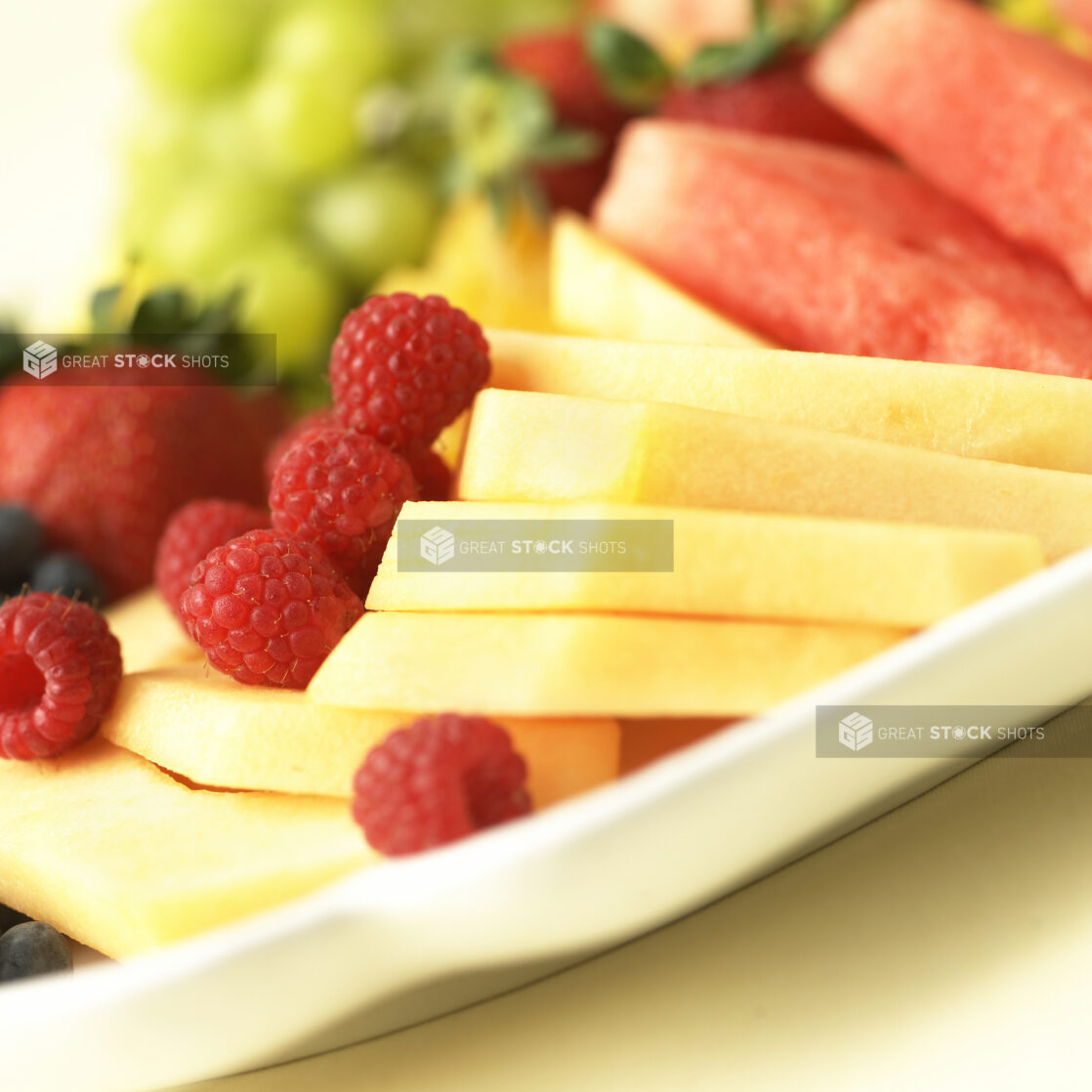 Close Up of Pineapples and Raspberries on a Fresh Fruit Catering Platter in an Indoor Setting