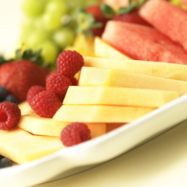 Close Up of Pineapples and Raspberries on a Fresh Fruit Catering Platter in an Indoor Setting