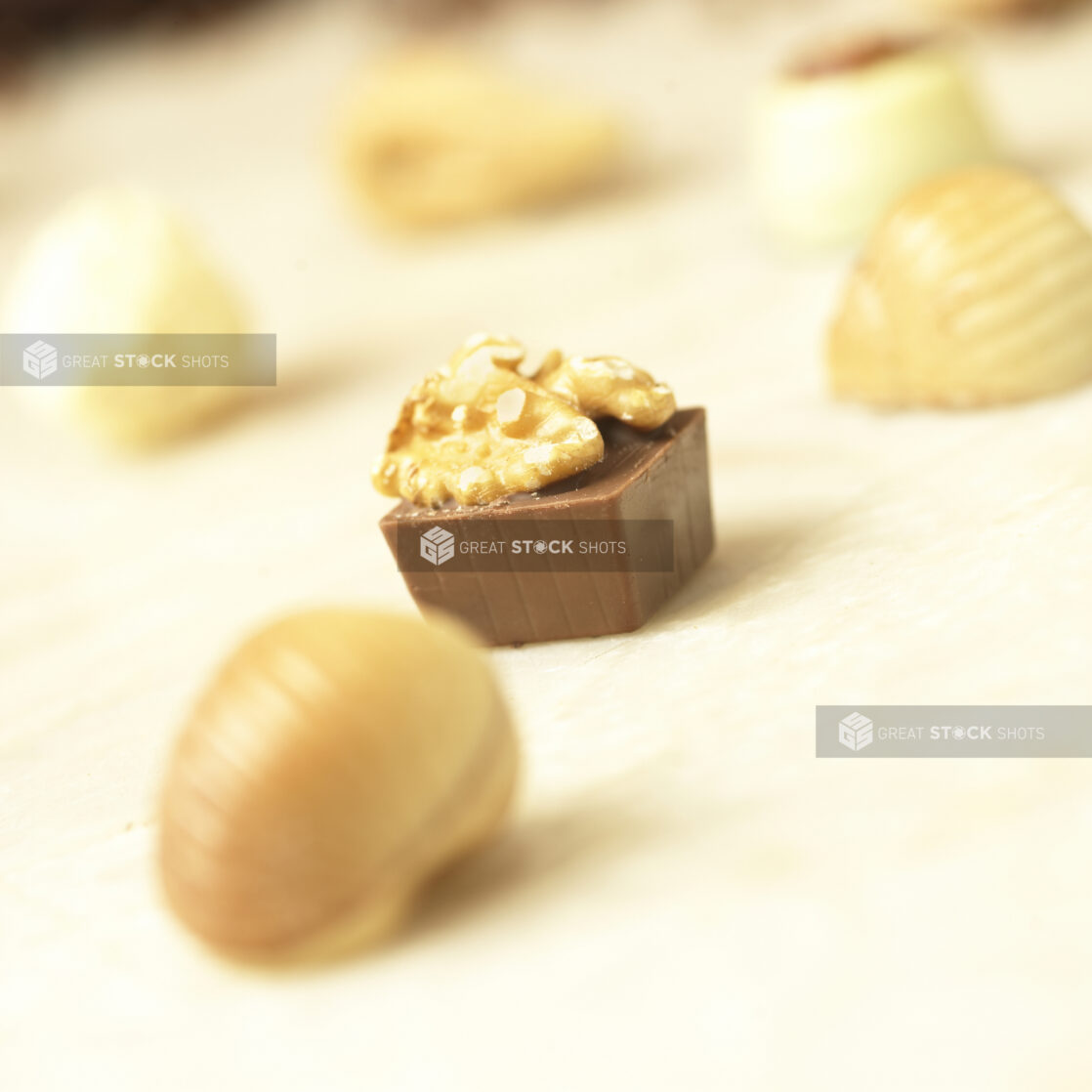 Close Up of a Milk Chocolate Walnut Square Truffle in an Indoor Setting