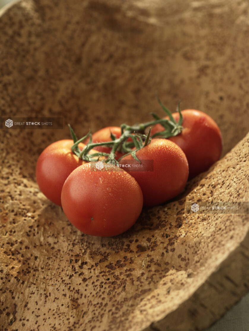 A Bunch of Vine-Ripened Whole Tomatoes on a Wooden Surface