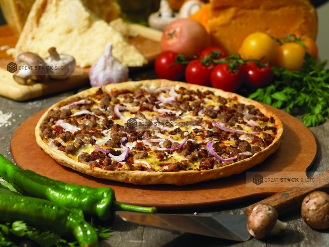 Specialty Cheeseburger Pizza with a Thin Crust on a Wooden Pizza Peel in an Indoor Setting