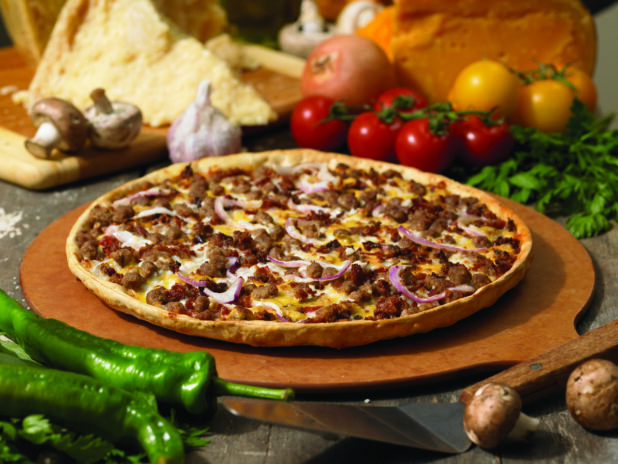 Specialty Cheeseburger Pizza with a Thin Crust on a Wooden Pizza Peel in an Indoor Setting