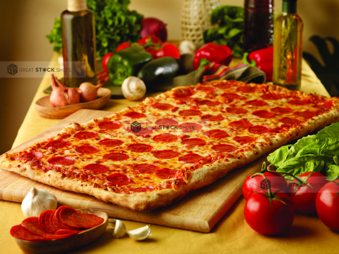 Party-Sized Pepperoni Pizza on a Wooden Cutting Board in an Indoor Setting