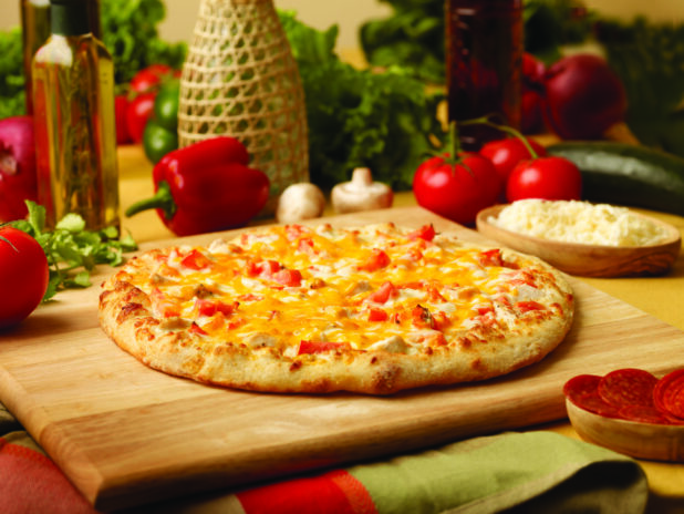 Chicken, Tomato and Cheddar Pizza on a Wooden Cutting Board in an Indoor Setting