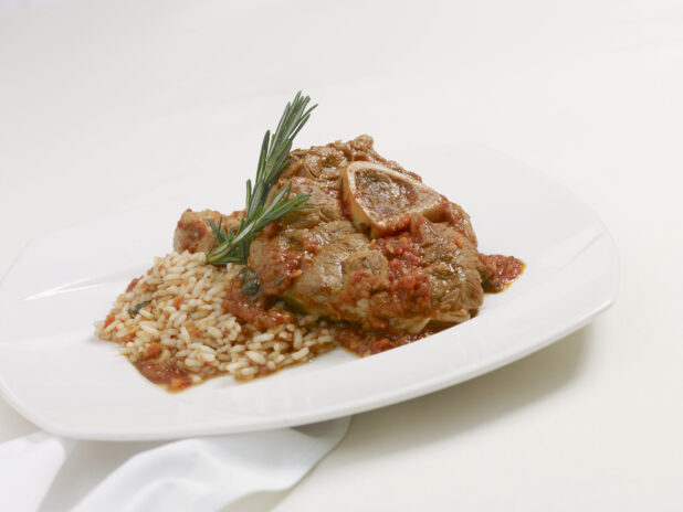 Ossobuco with Vegetable Risotto on a White Ceramic Dish