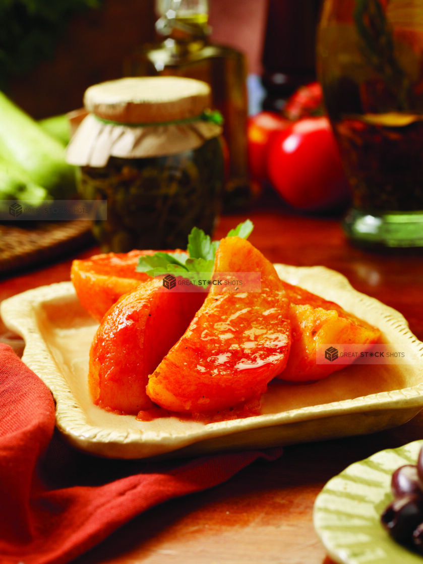 Close Up of a Side Dish of Roasted Greek Potatoes on a Wooden Table